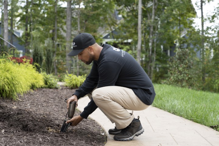 Loco Lighting founder installing outdoor lighting fixture